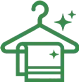 Green icon of a clothes hanger holding a folded towel with sparkle symbols, indicating cleanliness or freshness.